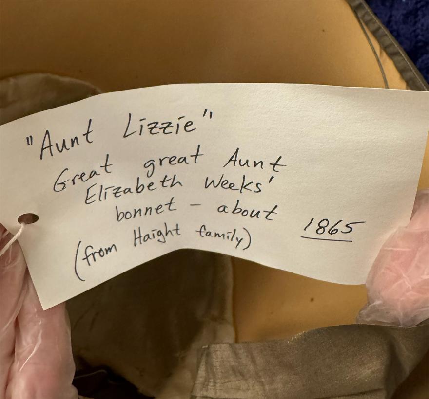 A tag attached to an old Quaker bonnet. The tag reads: "Aunt Lizzie" Great great Aunt Elizabeth Weeks' bonnet -- about 1865 (from Haight family) 
Nancy Hadley-Jaffe says this bonnet is from Quarterly Meeting/15th Street Meeting's small collection of plain Quaker dress from the mid 19th century.