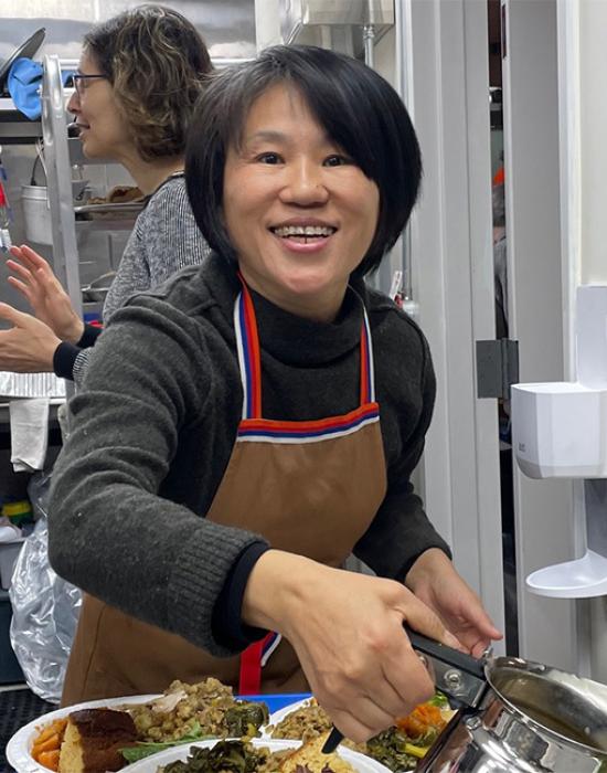 Jing Jia serving gravy community dinner 540 650