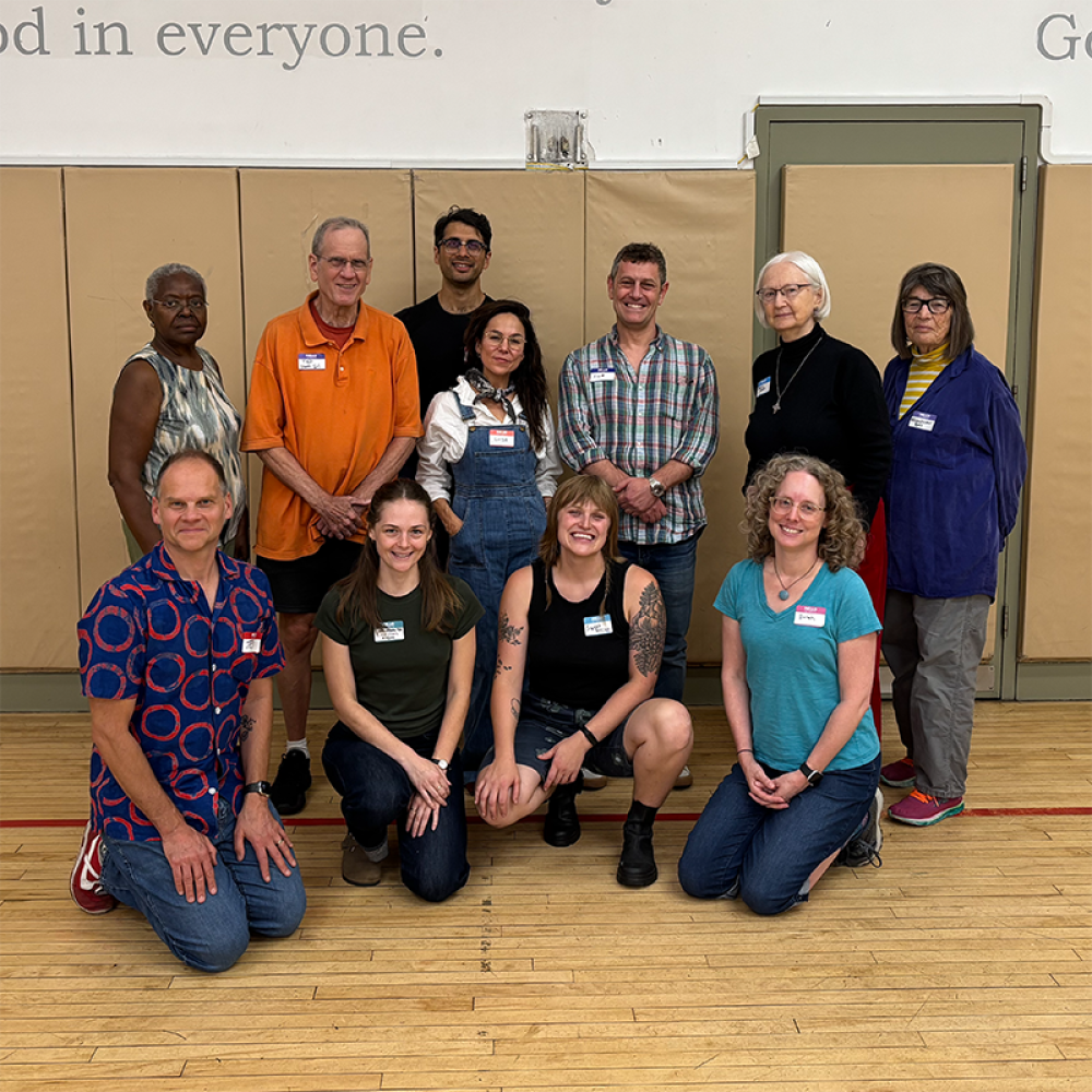 A group of NYC Quakers posing for a photo in the common room at 15 Rutherford Place. Friends were gathered for the clerks dinner in the fall of 2025.